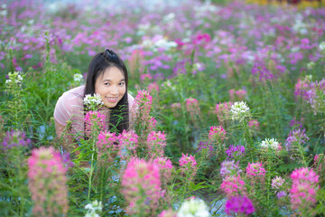 Obraz na płótnie Canvas Beautiful asian woman in the flower garden with nature background.