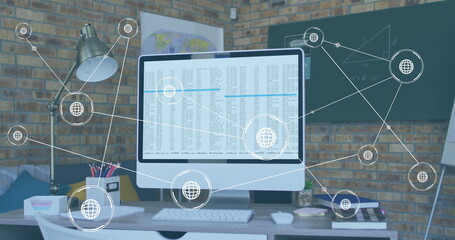 Image of network of conncetions with icons over computer with data processing on desk