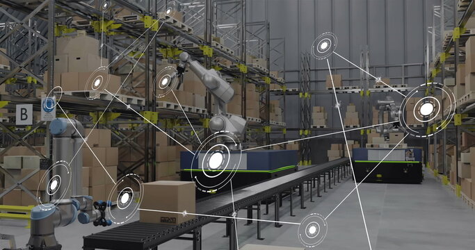Image of network of conncetions with icons over robotic arms with boxes in warehouse