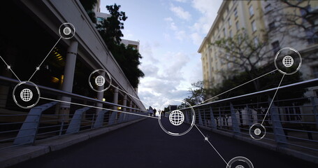 Image of network of conncetions with icons over people walking on street