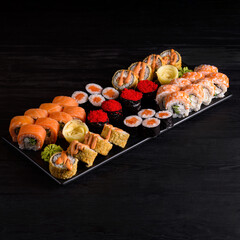 assorted rolls. on a black wooden background.