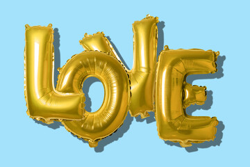 Word love in english alphabet from gold balloons on a bright background. Minimal love concept.