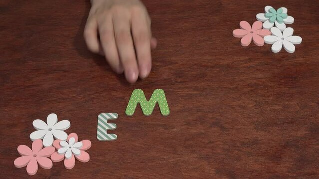 Female hand arranging the letters EMDR. Eye Movement Desensitization and Reprocessing psychotherapy treatment concept.