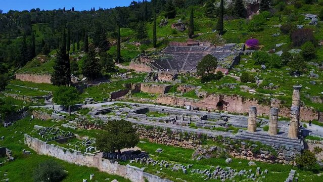 Apollo Temple in Delphi with a stunning aerial reveal by a smooth dolly shot pulling out shot, Greece.