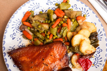 Close-up of a smoked pork chop with seasoned vegetables