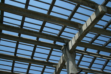 A detailed view of a shiny metal structure against a vibrant blue sky, showcasing its intricate design and craftsmanship.