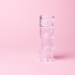 Creative layout of ice cubes on pastel pink background. Minimal