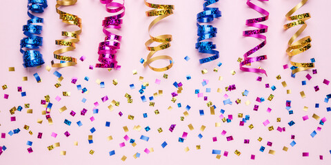 Colorful celebration concept with party confetti on pink background. Minimal party concept. Flat lay.