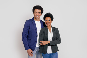 Portrait of confident business partners smiling and posing together on isolated white background
