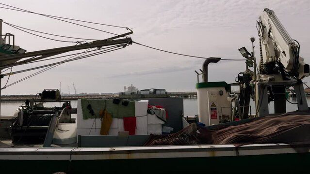Trawlers in the port of Spain in winter. Fishing boats are moored at the pier. A port in the Mediterranean Sea on a sunny day in February.