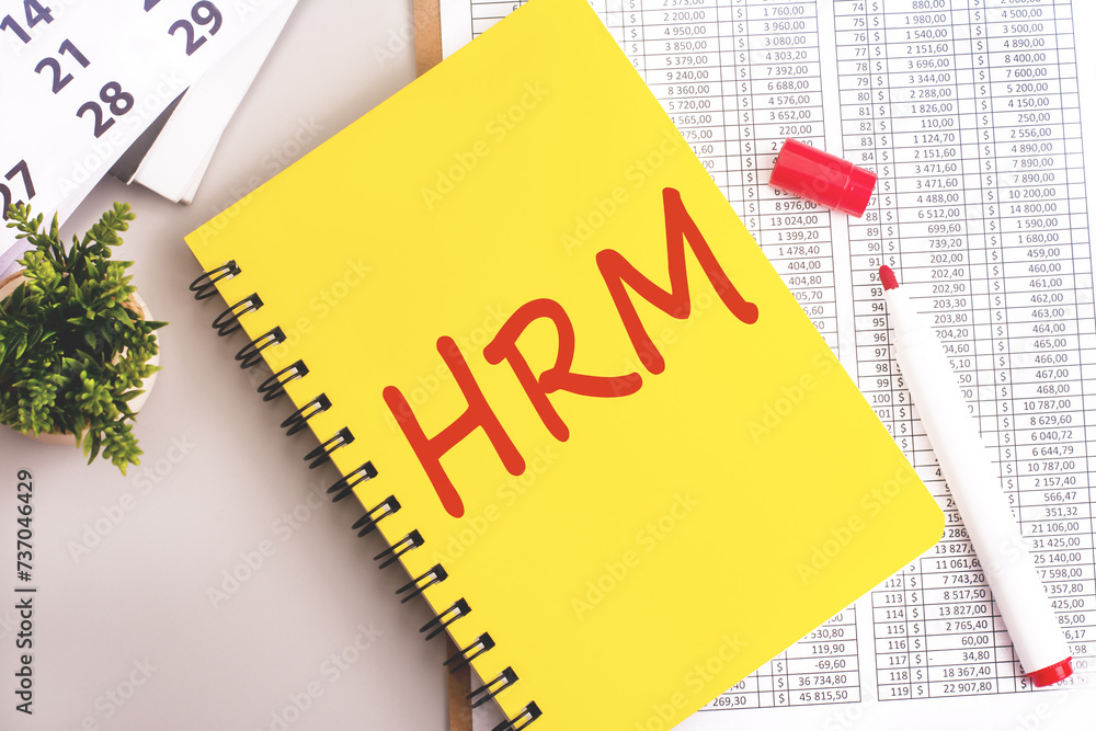 Poster yellow notebook with toolls and notes about hrm. human resource management concept