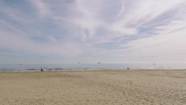 A walk on a sandy beach in Spain. A warm winter day in the sand dunes of Grao. Castellon