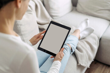 Selective focus on woman hold computer tablet with empty display in hands