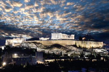 Panorama of Acropolis hill at night, Athens, Greece. Famous old Acropolis is a top landmark of Athens. Ancient Greek ruins in the Athens center at dusk
