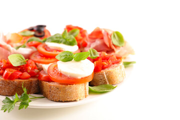 assortment of canape, bruschetta, toast with tomatoes, mozzarella and basil