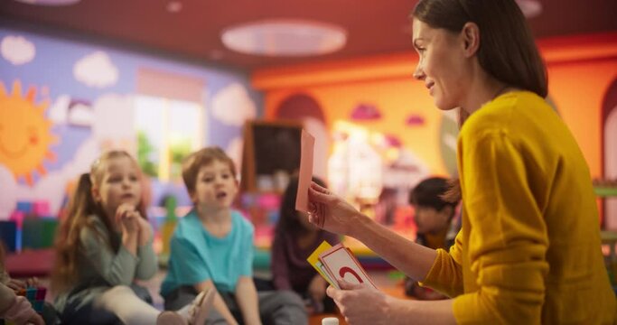 Cheerful Daycare Teacher Using Gaming and Acting Methods to Teach Multiethnic Kids Alphabet in Kindergarten. Small Cute Boys and Girls Getting Basic Reading and Writing Skills, Learning Alphabet