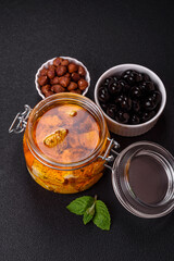 Delicious soft white feta cheese with salt, spices and herbs on a dark concrete background