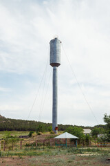 zinc metal water tower in mountainous area in summer