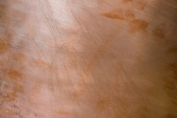 Copper background. Metal plate. Scratches. Lighting effect. Design background. Copy space.