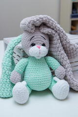 plush bunny in a wooden box with long ears, soft toy