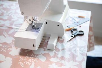 Sewing machine and some accessories, workspace at home or workshop.