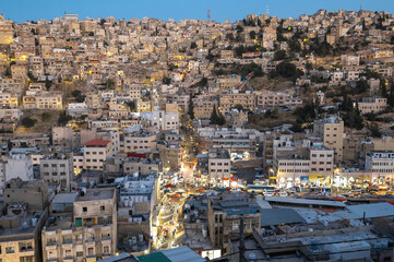 Captivating skyline of Amman, Jordan traditional houses atop a picturesque hill during blue hour