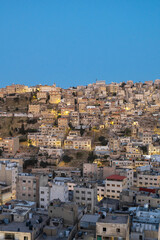 Captivating skyline of Amman, Jordan traditional houses atop a picturesque hill during blue hour - 737103426