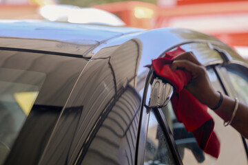 Car polishing series Worker polishing a car with microfiber cloth
