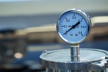 metal container with pressure gauge on the lid