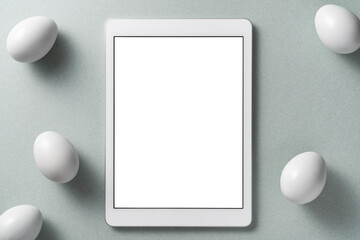 Digital tablet mockup with white eggs on gray background