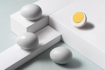 White eggs on layered background, still life, high angle shot