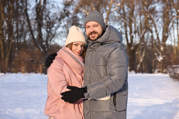 Family portrait of beautiful couple in snowy park