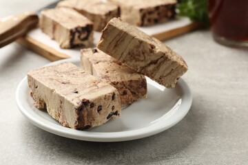 Tasty chocolate halva on grey table, closeup