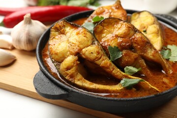 Tasty fish curry on table, closeup. Indian cuisine