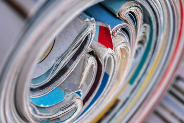 Macro view of old rolled up colored newspapers