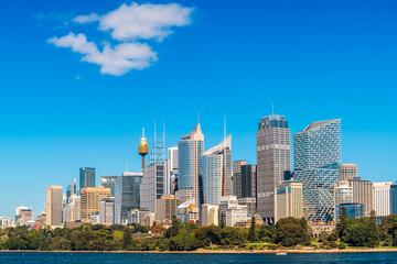 Modern Sydney City skyline with skyscrapers and office buildings viewed from ferry on bright sunny day
