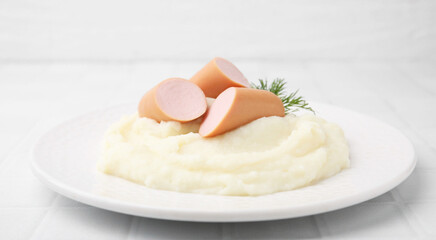 Delicious boiled sausages, mashed potato and dill on white table, closeup