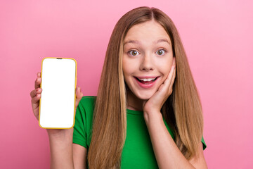 Photo of cheerful lovely excited girl wear green trendy clothes showing modern device empty space...