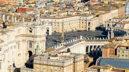 Aerial view of the colonnade and St. Peter's square located in the Vatican city. This state is an enclave within the city of Rome, Italy. The obelisk in the center is known as 