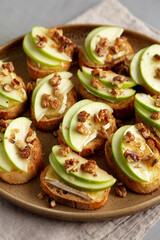 Homemade Apple Brie Crostinis on a Plate, side view. Close-up.