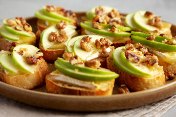 Homemade Apple Brie Crostinis on a Plate, side view.