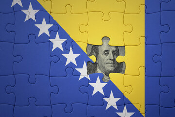 puzzle with the national flag of bosnia and herzegovina and usa dollar banknote. finance concept