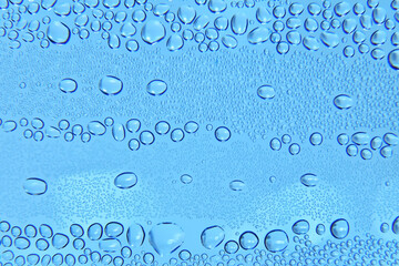 Water bubbles close up view. Raindrops on glass