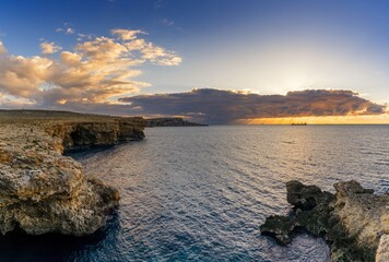 sunset seascape in Malta with the Popeye Cliffs and a view of the ocean at Anchor Bay
