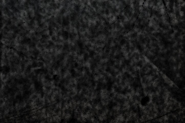 A black background with scratches and stains