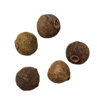 Dry allspice peas on isolated background, top view.