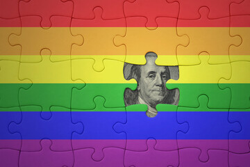 puzzle with the rainbow gay pride flag of and usa dollar banknote. finance concept