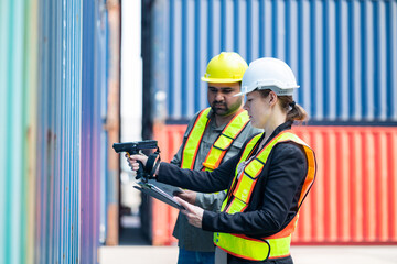 Warehouse engineer inspects the inside of a container with a customer at an industrial container yard.