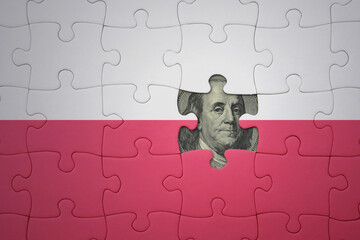 puzzle with the national flag of poland and usa dollar banknote. finance concept