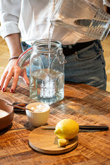 Pouring water into fermentation jar for fermented beverage preparation